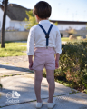 Conjunto de niño con tirantes azul y pantalón rosa.